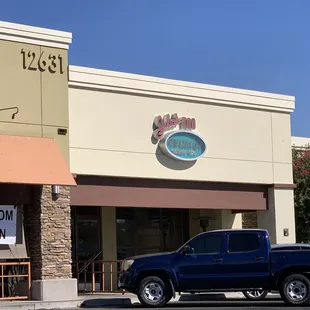 a truck parked in front of a restaurant