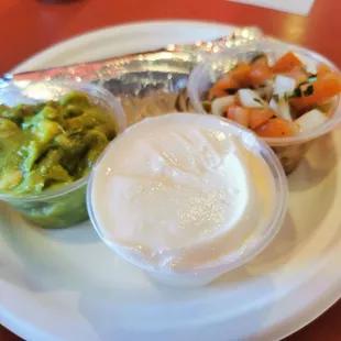 a plate of guacamole, shrimp, and guacamole