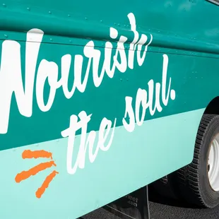 the side of a bus with the words nourish the soul painted on it