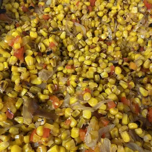 a mixture of corn and onions in a pan