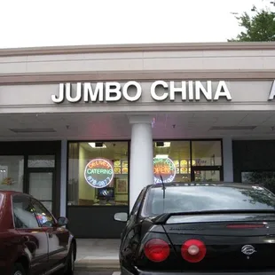 two cars parked in front of a restaurant