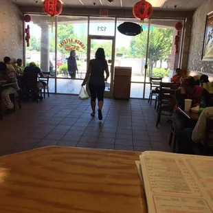 a woman walking through a restaurant