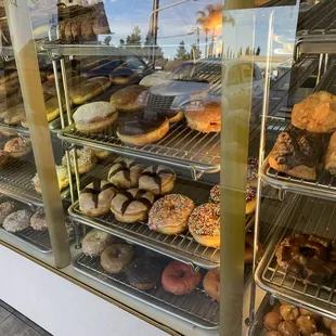 a variety of donuts in a display case