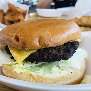 a hamburger with cheese and lettuce