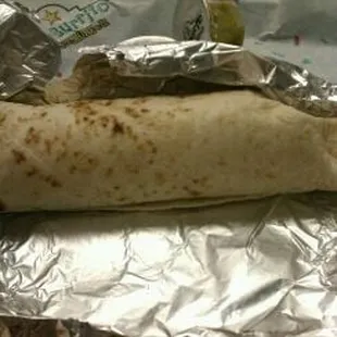 a burrito wrapped in aluminum foil