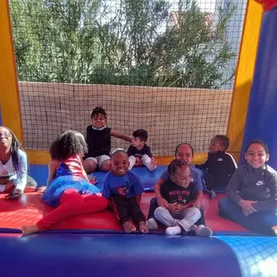 All the happy kids in the spiderman bouncey house.
