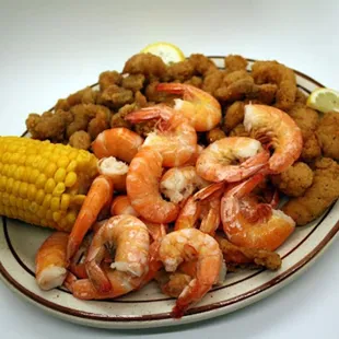 a plate of shrimp and corn