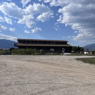 large building with mountains in the background