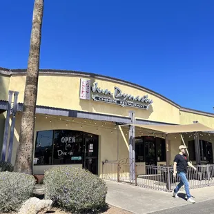 a man walking in front of the restaurant