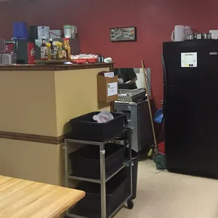 a kitchen with a black refrigerator