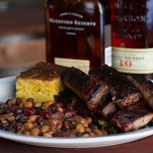 a plate of ribs, beans and cornbreads