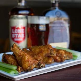 a plate of wings and celery