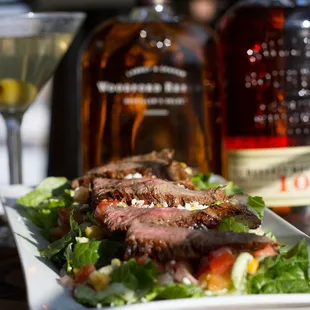 steak and salad with a martini