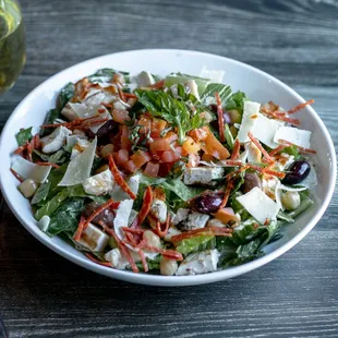 a bowl of salad and a glass of wine