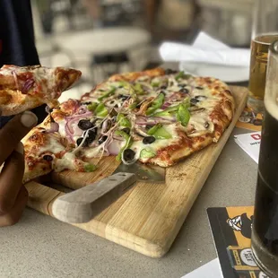 a person holding a slice of pizza