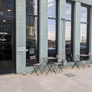 tables and chairs in front of a building