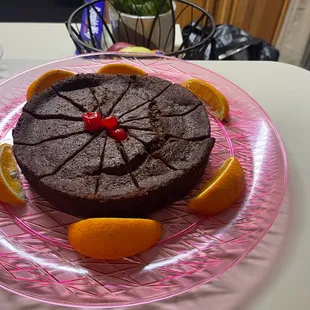 a chocolate cake with orange slices