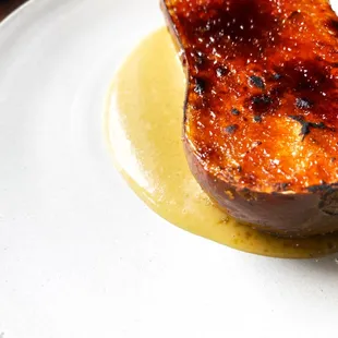 a white plate with a piece of food on it