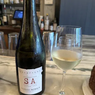 a glass of wine and a bottle of wine