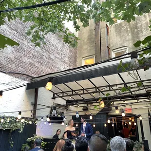 a crowd of people standing in front of a building