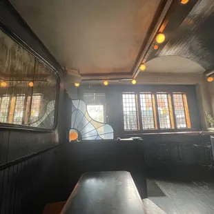 the interior of a restaurant with stained glass windows