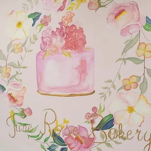 a cake with flowers painted on the wall