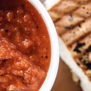 a bowl of chili and a grilled cheese sandwich