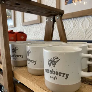 a row of coffee mugs on a shelf