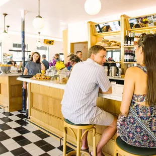 a group of people sitting at a bar