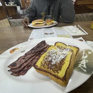 a plate of french toast and bacon