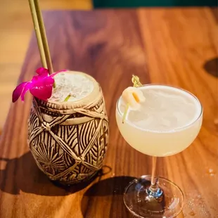 two cocktails on a wooden table