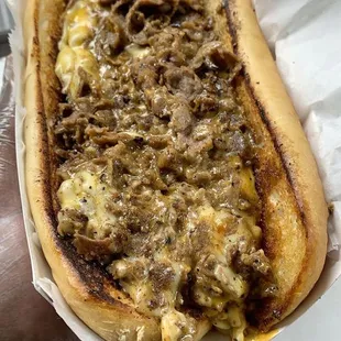 a hand holding a hot dog