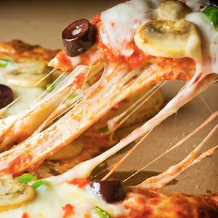 a slice of pizza being lifted by a fork