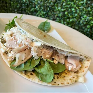 a tortilla with chicken and spinach