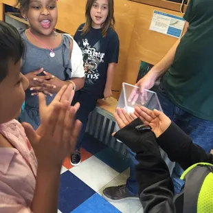 Ryan letting the kids hold the cockroach