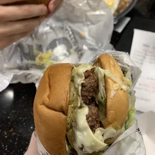 a person holding a sandwich