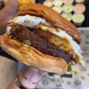 a person holding a sandwich