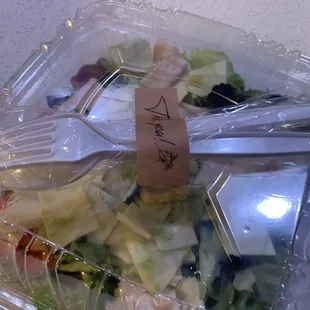 a salad in a plastic container
