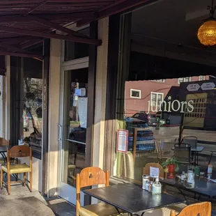 A couple little outdoor tables frame the doorway, but they also have a bigger outdoor section in the street.