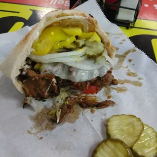 a pulled pork sandwich with pickles