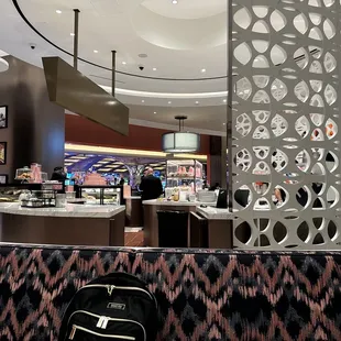 a woman standing at a counter in a restaurant