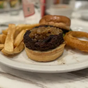 Steak burger with onion rings and steak fries