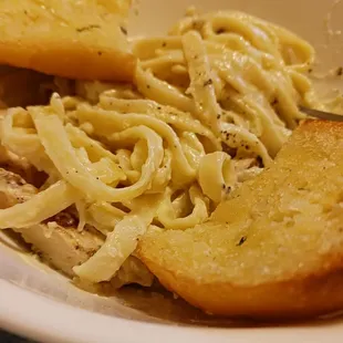 a plate of pasta and bread