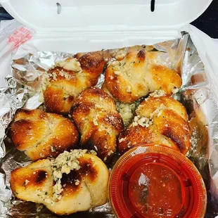 a container of pizza and sauce