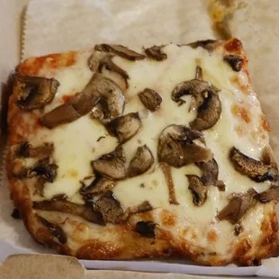 a slice of mushroom pizza