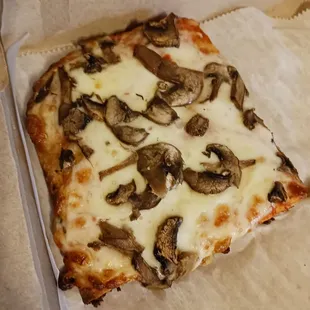 a slice of mushroom pizza