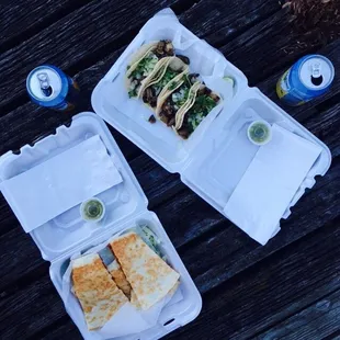 two takeout containers on a picnic table