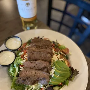  a plate of food and a bottle of wine