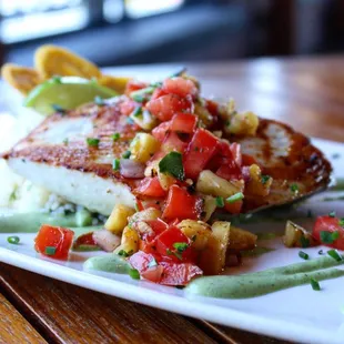 Pan Seared Wahoo with grilled pineapple and chipotle salsa over cilantro lime rice with grilled plantains.