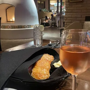 a glass of wine and a plate of food